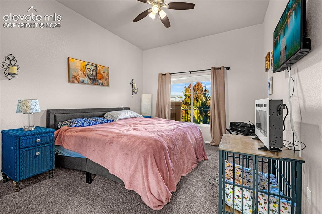 Image 19 of 27: High-ceilinged room featuring neutral wall tones, carpeted flooring, a ceil