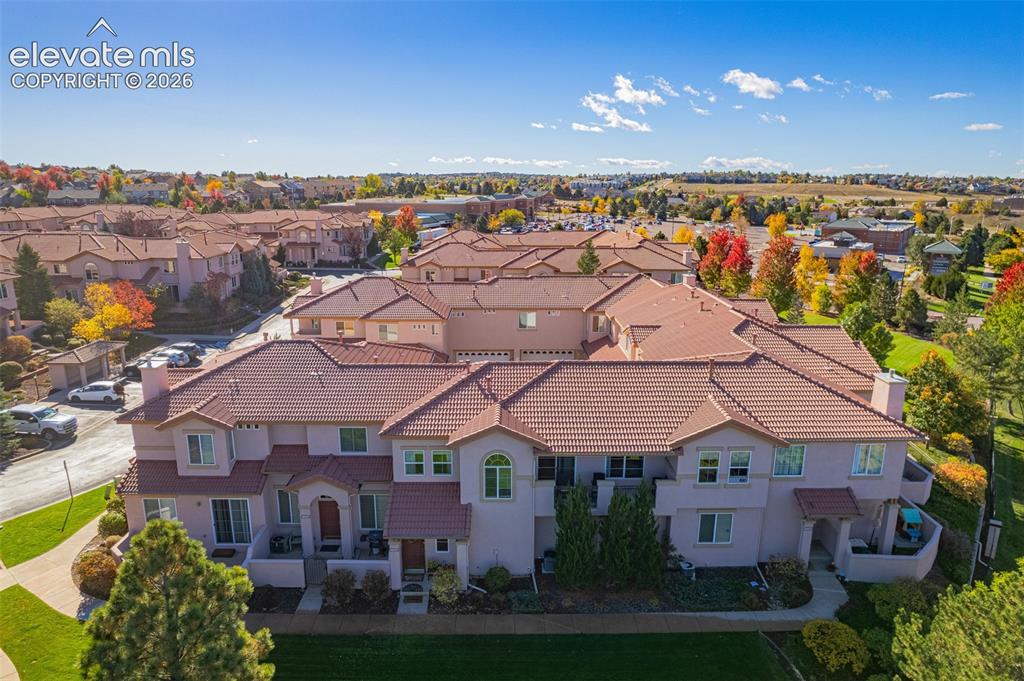 Image 2 of 27: Multi-unit residential complex featuring a tile roof, stucco exterior, inte