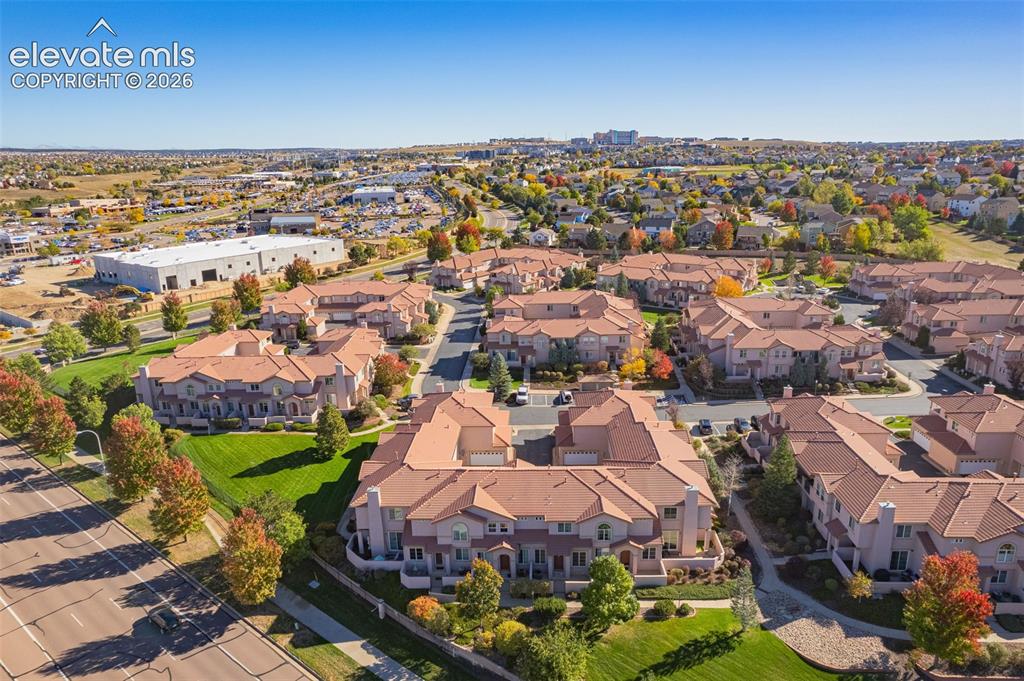 Image 24 of 27: Aerial perspective of a multi-unit residential community featuring terracot
