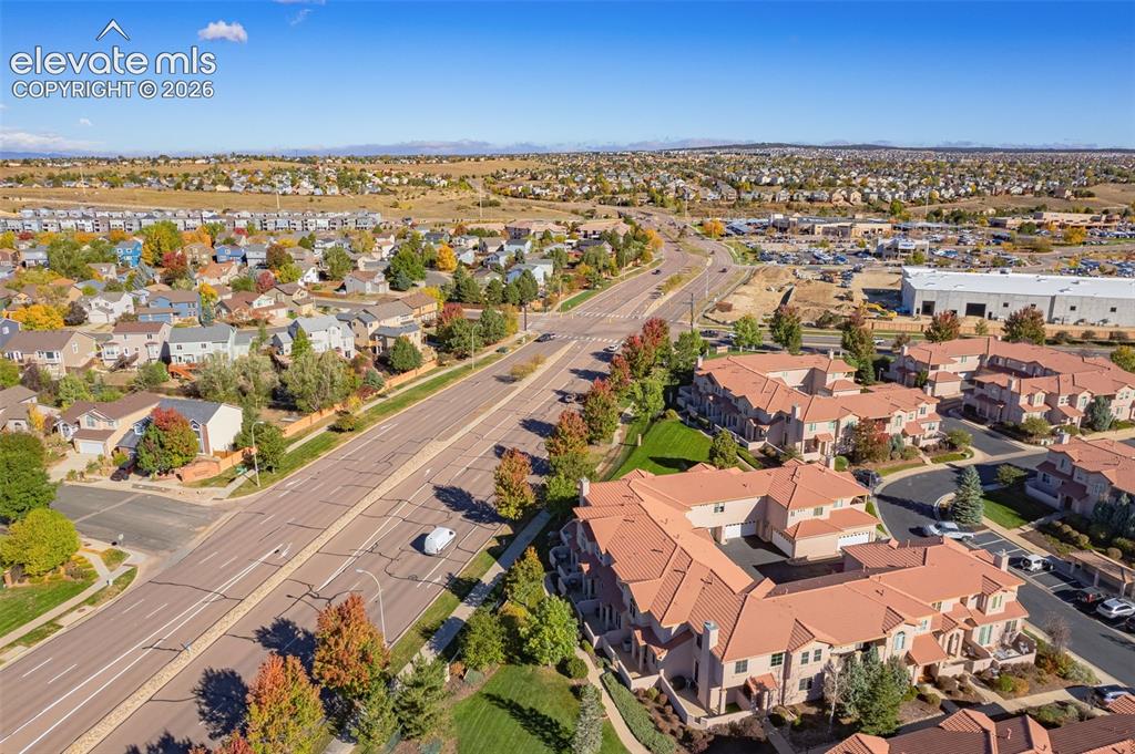 Image 26 of 27: Aerial perspective of a multi-unit residential complex featuring terracotta