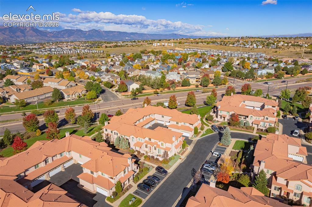 Image 27 of 27: Aerial perspective of a multi-unit residential complex featuring terracotta