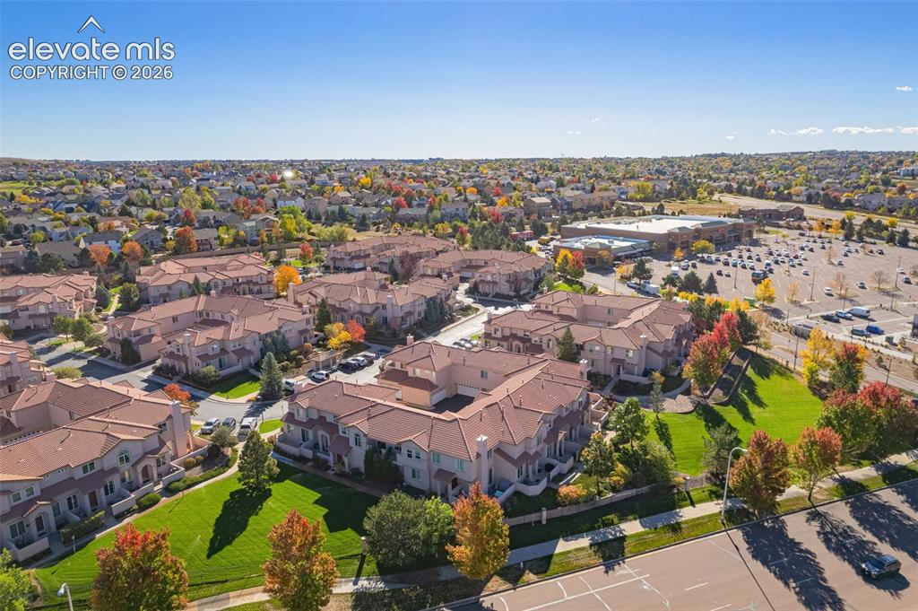 Image 3 of 27: Aerial perspective of a multi-unit residential complex featuring terracotta