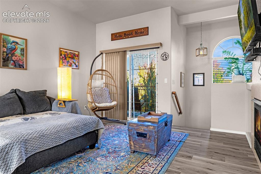 Image 6 of 27: Sliding glass door, wood-finish flooring, arched window, and built-in firep