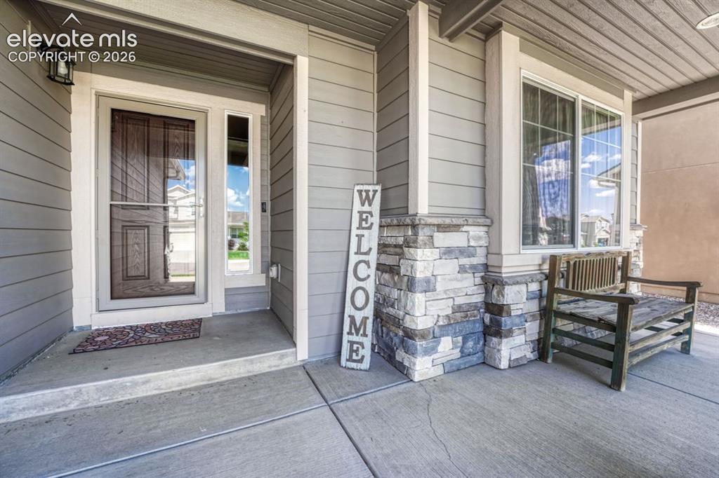 Image 10 of 50: Covered front entryway with covered porch
