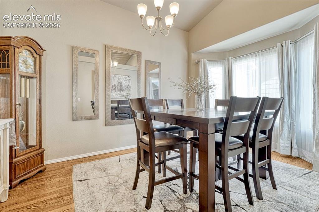 Image 18 of 50: Formal Dining Room featuring wood-finish flooring and a bay window with nat