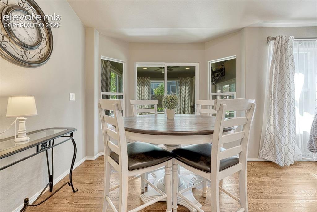 Image 21 of 50: Dining area featuring wood-finish flooring and a walk out to the enclosed s