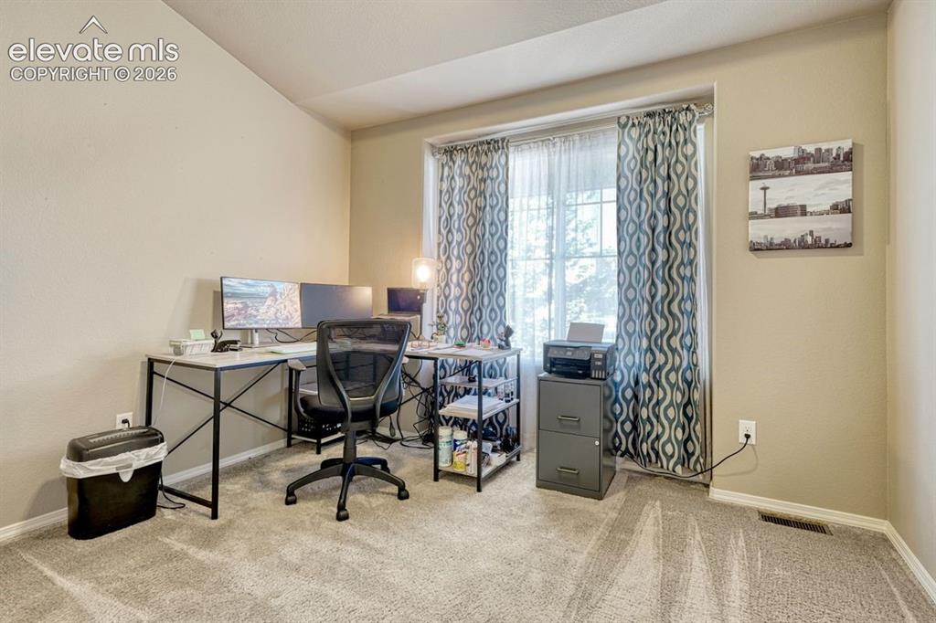 Image 28 of 50: Bedroom featuring light-colored walls and carpeting - used as office
