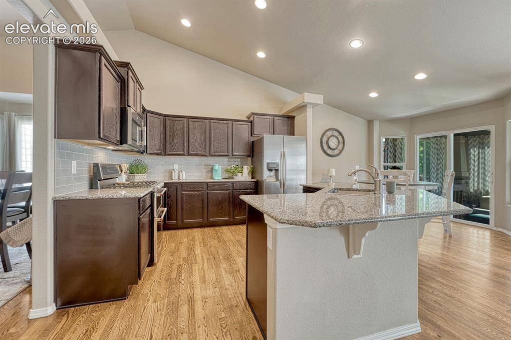Image 3 of 50: Spacious kitchen featuring an expansive island with a double basin sink and