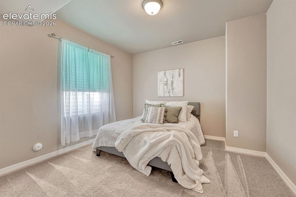 Image 37 of 50: Neutral-toned bedroom
