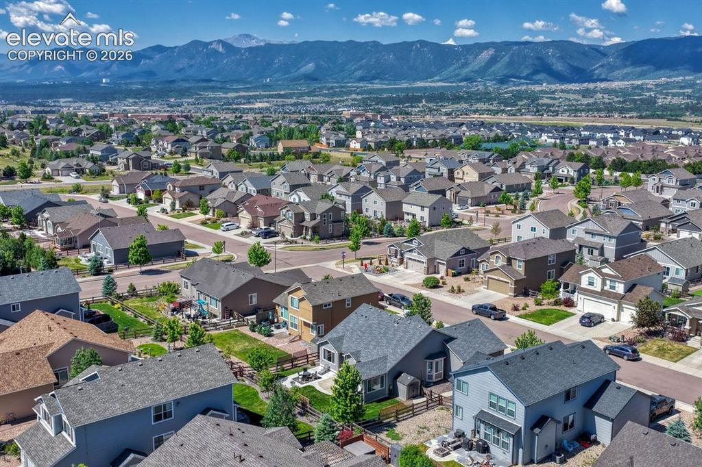 Image 46 of 50: Residential neighborhood with diverse architectural styles, featuring pitch