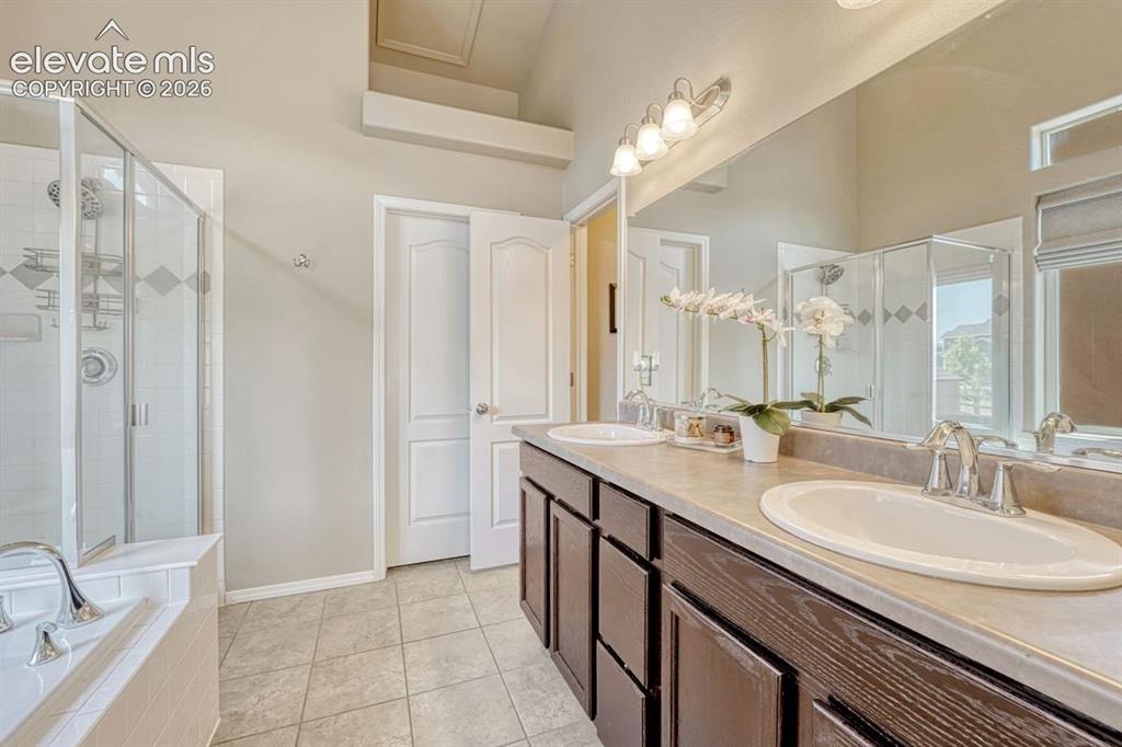 Image 5 of 50: Primary Bathroom 5-pce bath with dual sink vanity