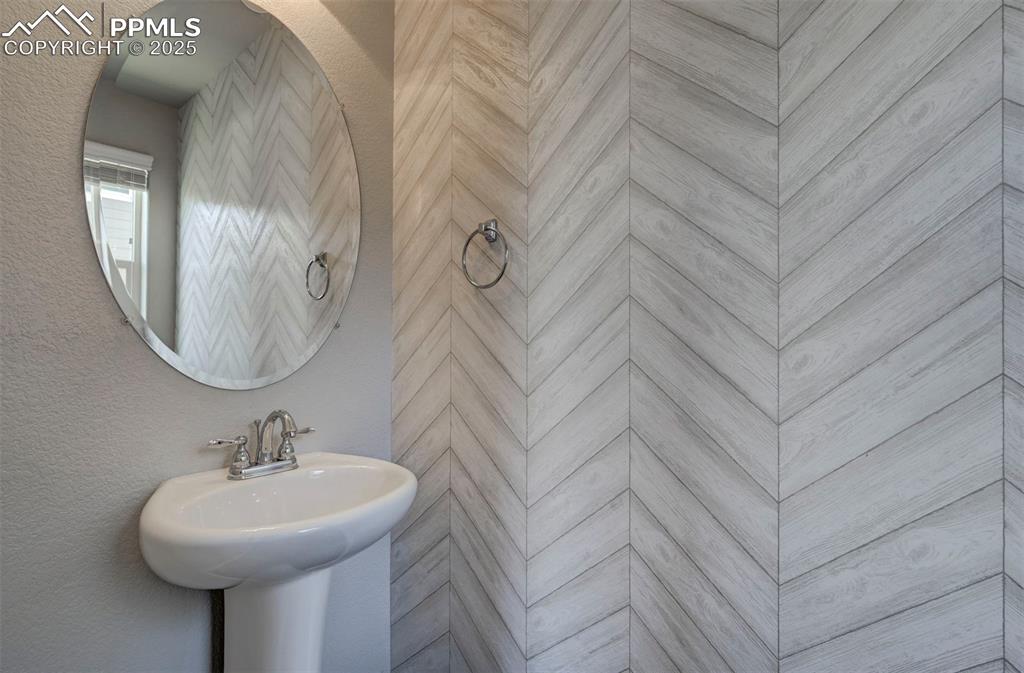 Image 10 of 50: Bathroom featuring a sink and tiled shower