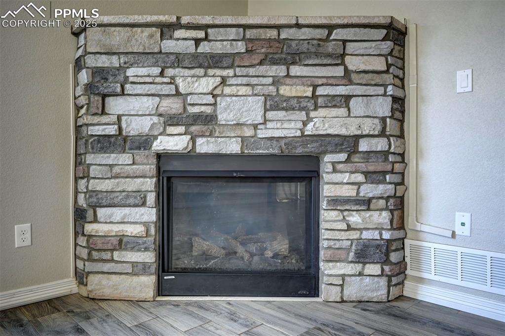 Image 15 of 50: Interior details with baseboards, wood finished floors, visible vents, and 