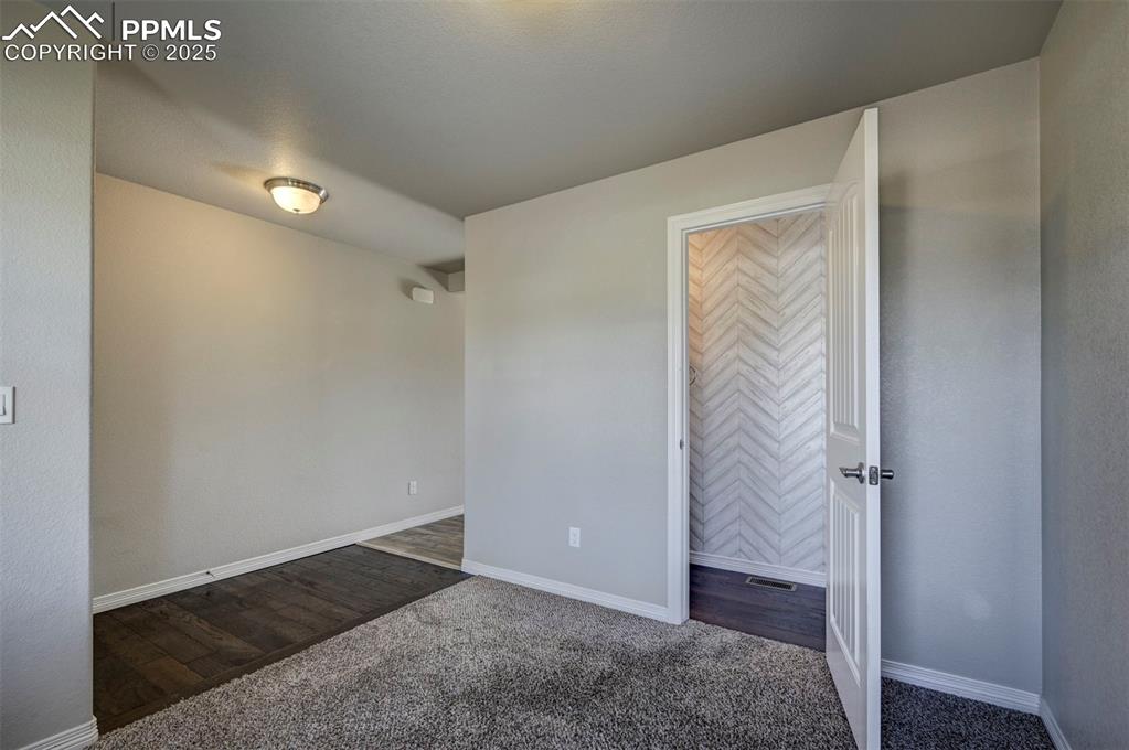 Image 16 of 50: Unfurnished bedroom with carpet floors and baseboards