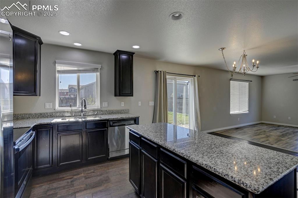 Image 19 of 50: Kitchen featuring stainless steel dishwasher, electric range, open floor pl