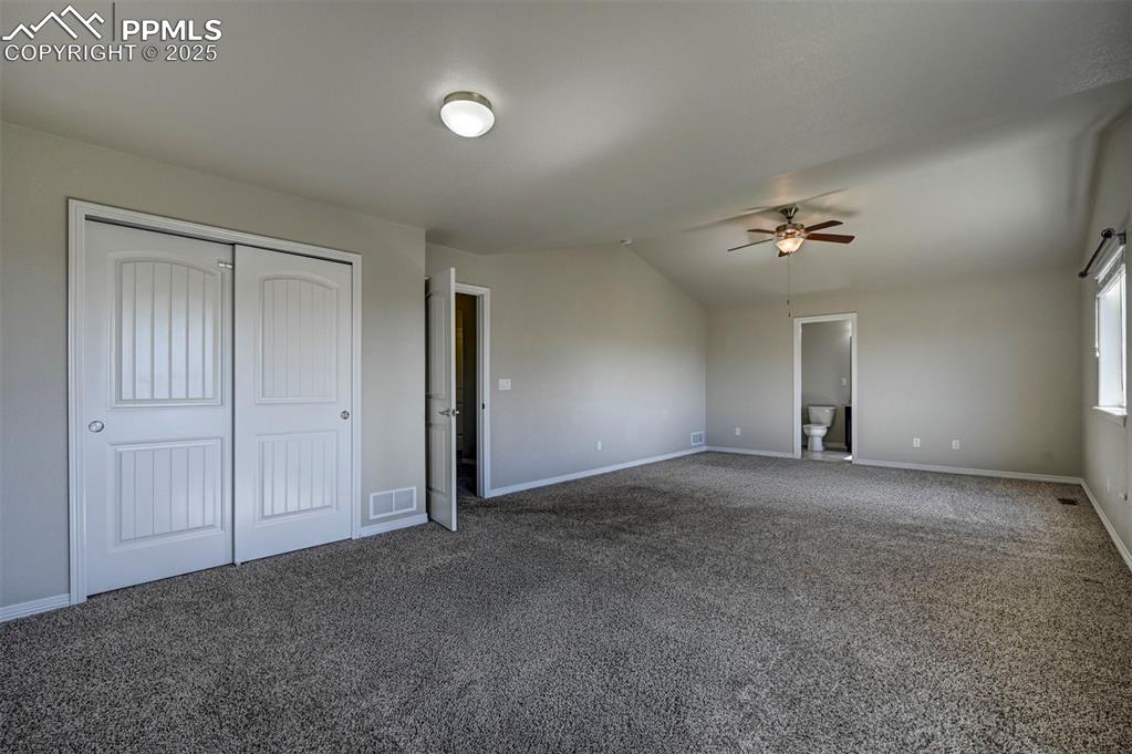 Image 27 of 50: Unfurnished bedroom featuring visible vents, carpet floors, baseboards, a c