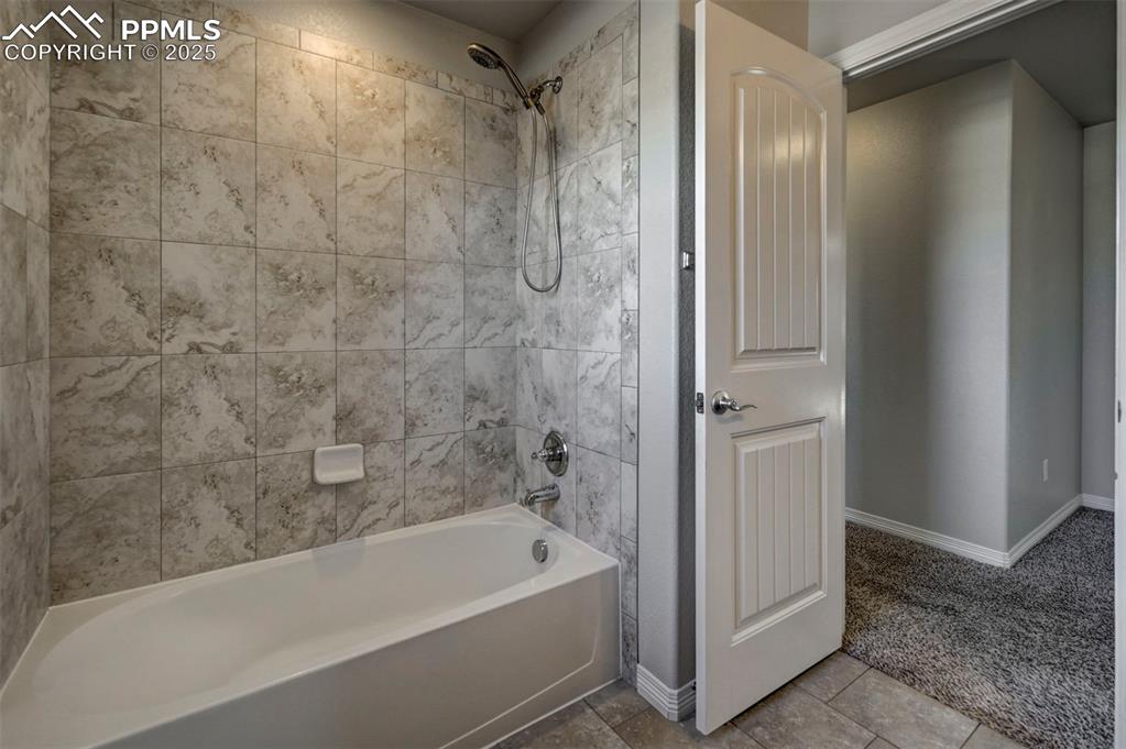 Image 37 of 50: Full bath featuring baseboards and bathing tub / shower combination