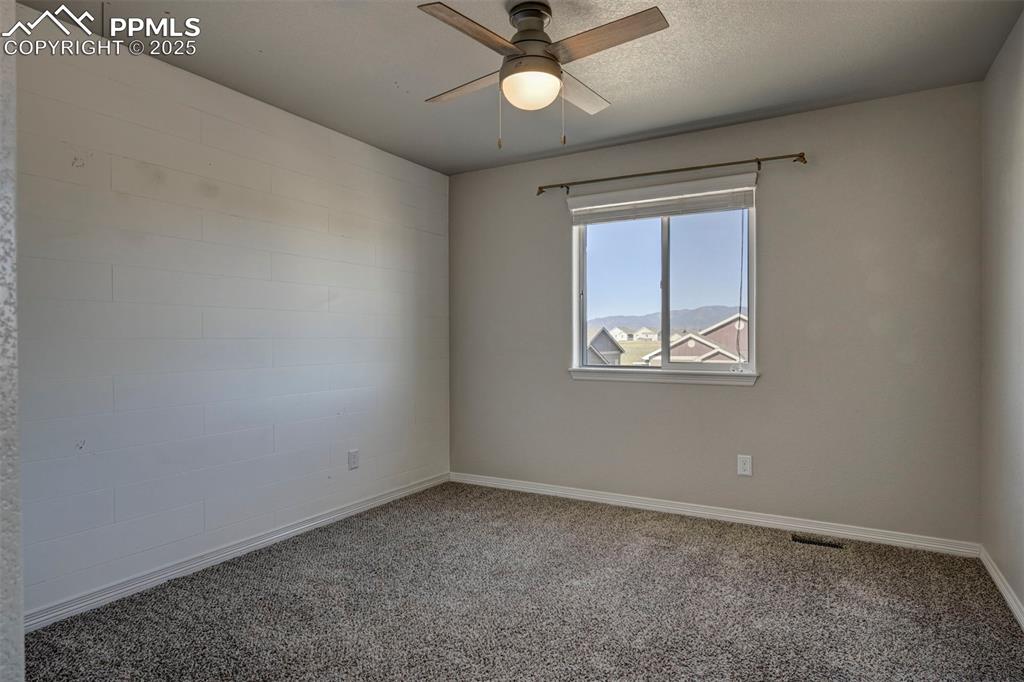Image 39 of 50: Unfurnished room featuring baseboards, a ceiling fan, carpet flooring, and 