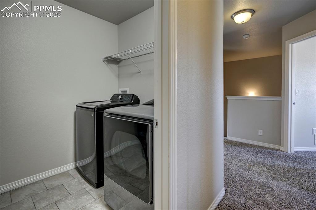 Image 40 of 50: Laundry area featuring baseboards, laundry area, and washing machine and dr