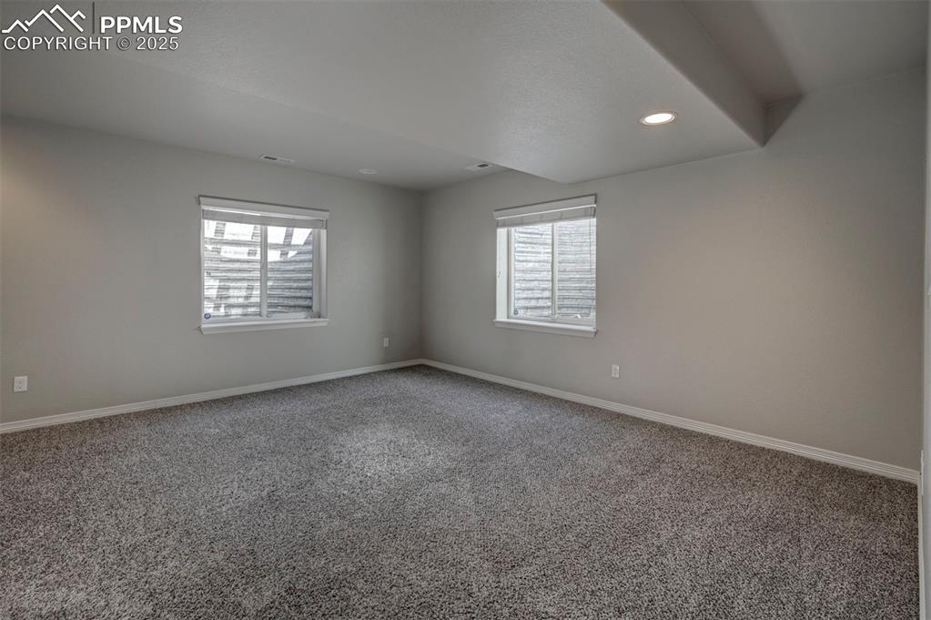 Image 42 of 50: Spare room with carpet floors, recessed lighting, baseboards, and a wealth 