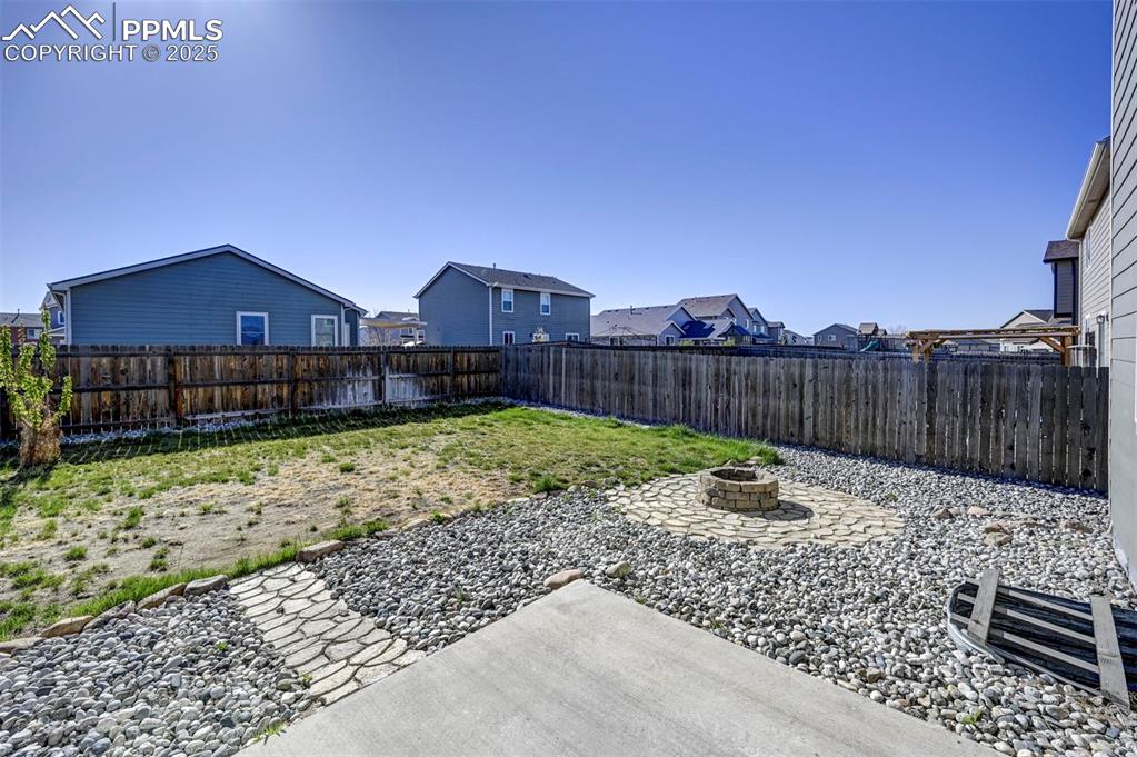 Image 48 of 50: View of yard featuring a fenced backyard, an outdoor fire pit, and a reside