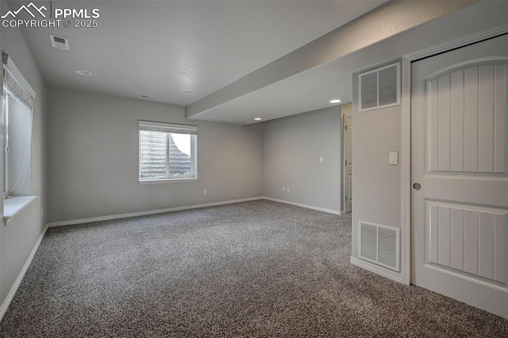 Image 49 of 50: Carpeted spare room featuring visible vents, recessed lighting, and baseboa