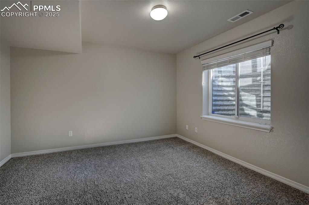 Image 50 of 50: Carpeted empty room featuring baseboards and visible vents