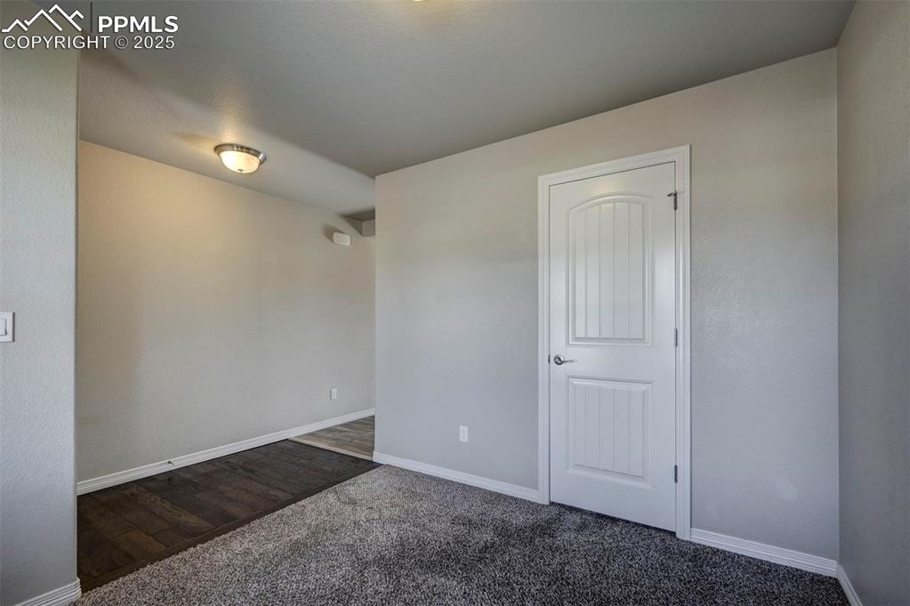 Image 8 of 50: Carpeted spare room with baseboards