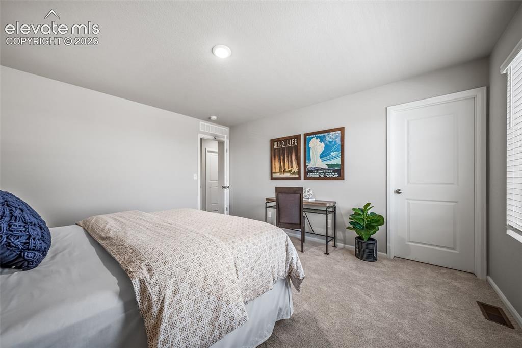 Image 5 of 21: Spacious room featuring neutral carpeting, light gray wall paint, and reces