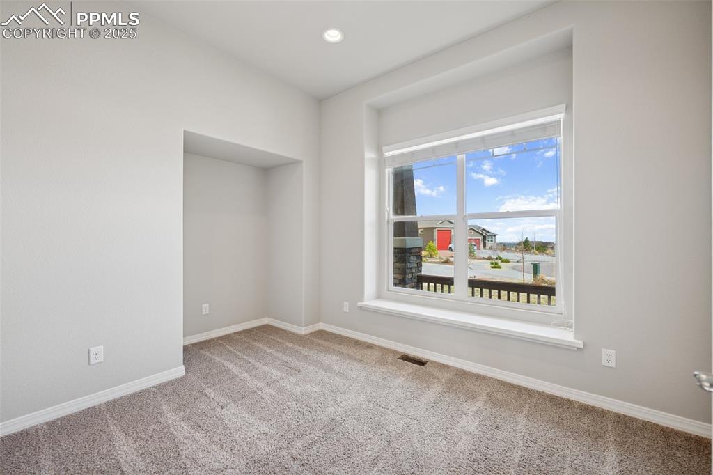 Image 12 of 38: Carpeted spare room featuring baseboards, recessed lighting, and visible ve