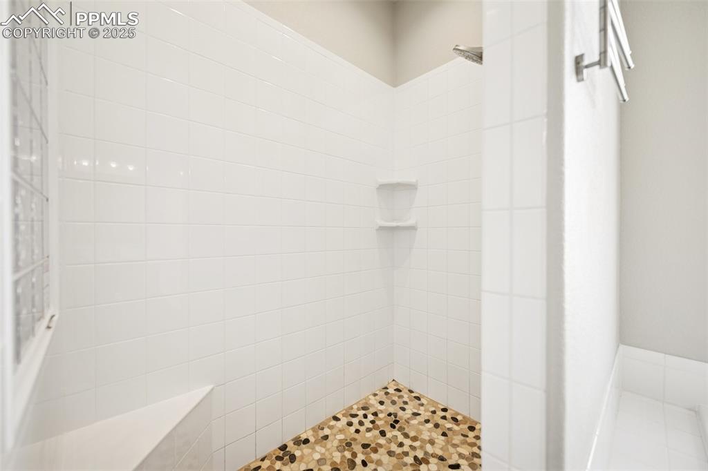 Image 20 of 38: Full bath with a tile shower