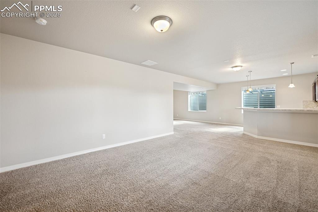Image 26 of 38: Empty room featuring baseboards and light carpet