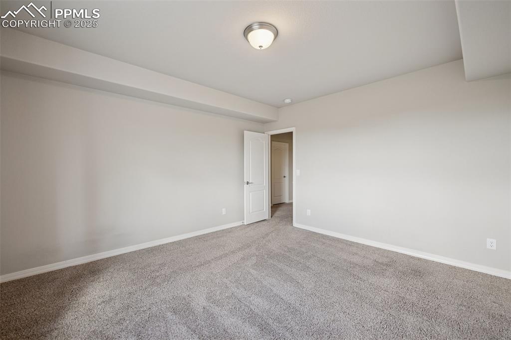 Image 29 of 38: Empty room featuring carpet floors and baseboards