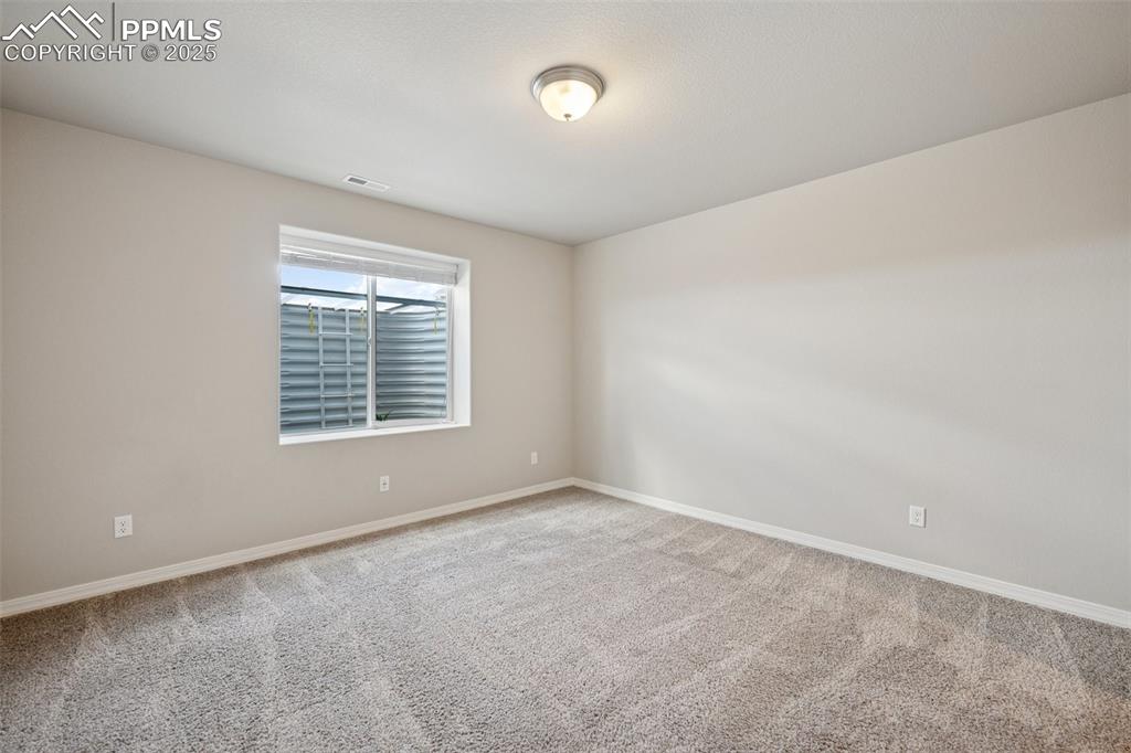 Image 30 of 38: Carpeted empty room featuring visible vents and baseboards