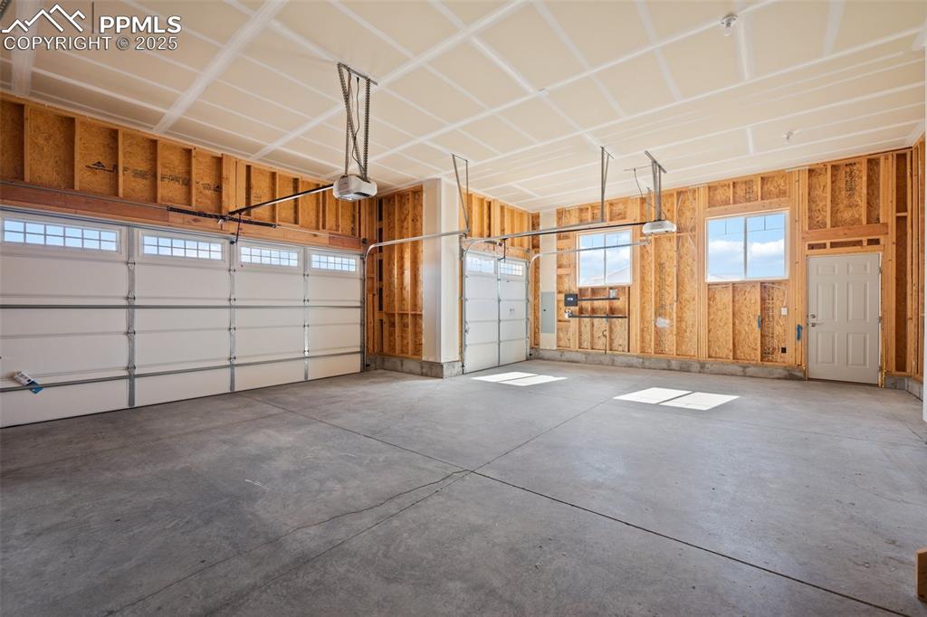 Image 32 of 38: Garage with a garage door opener