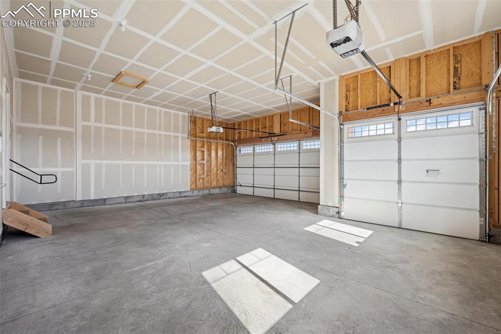 Image 33 of 38: Garage featuring a garage door opener