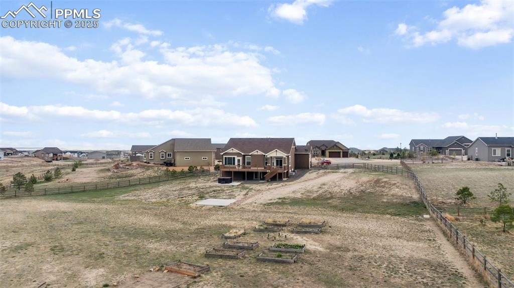 Image 37 of 38: View of yard featuring a garden, driveway, and a residential view