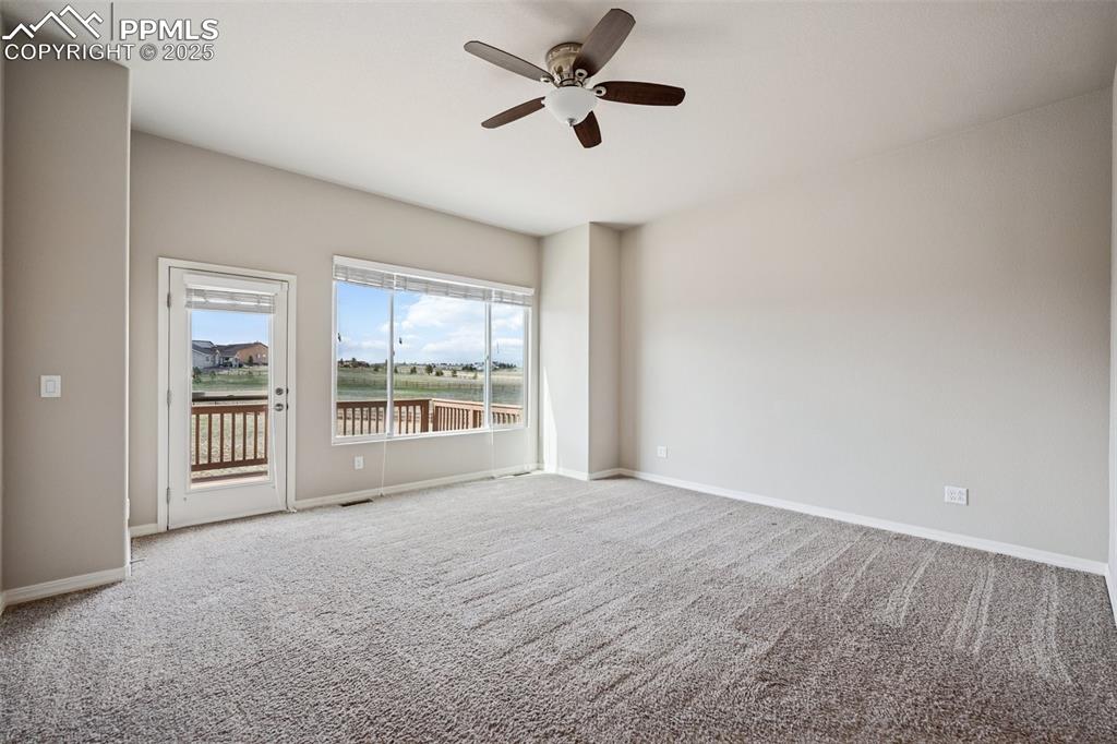 Image 8 of 38: Carpeted spare room with a ceiling fan, baseboards, and visible vents