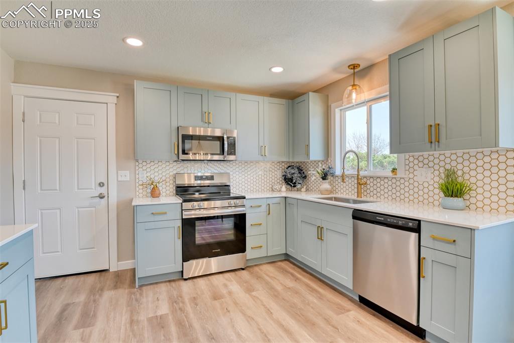 Image 6 of 31: Dining space featuring a chandelier, light wood-style floors, baseboards, a