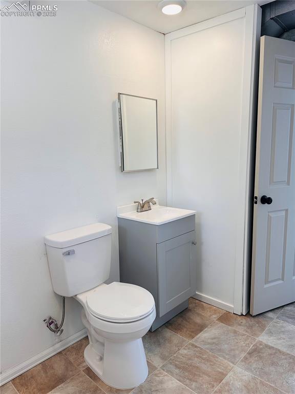 Image 10 of 11: Bathroom featuring vanity and stone finish flooring