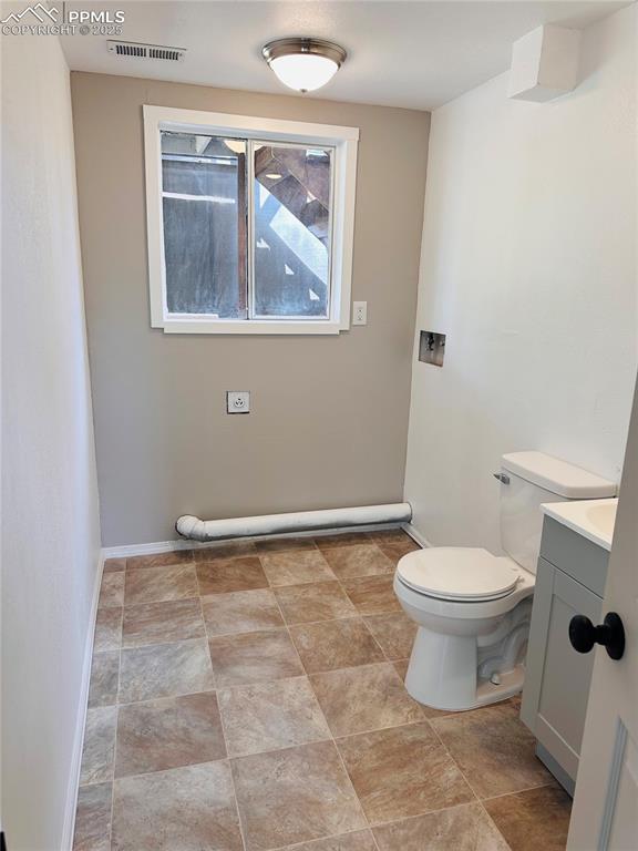 Image 11 of 11: Bathroom featuring vanity and toilet