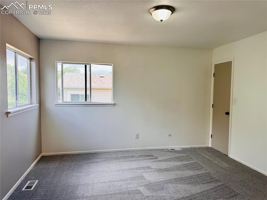 Image 4 of 11: Carpeted empty room featuring baseboards