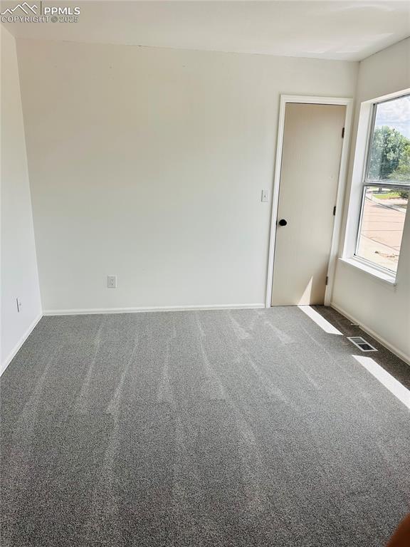 Image 7 of 11: Carpeted empty room featuring baseboards
