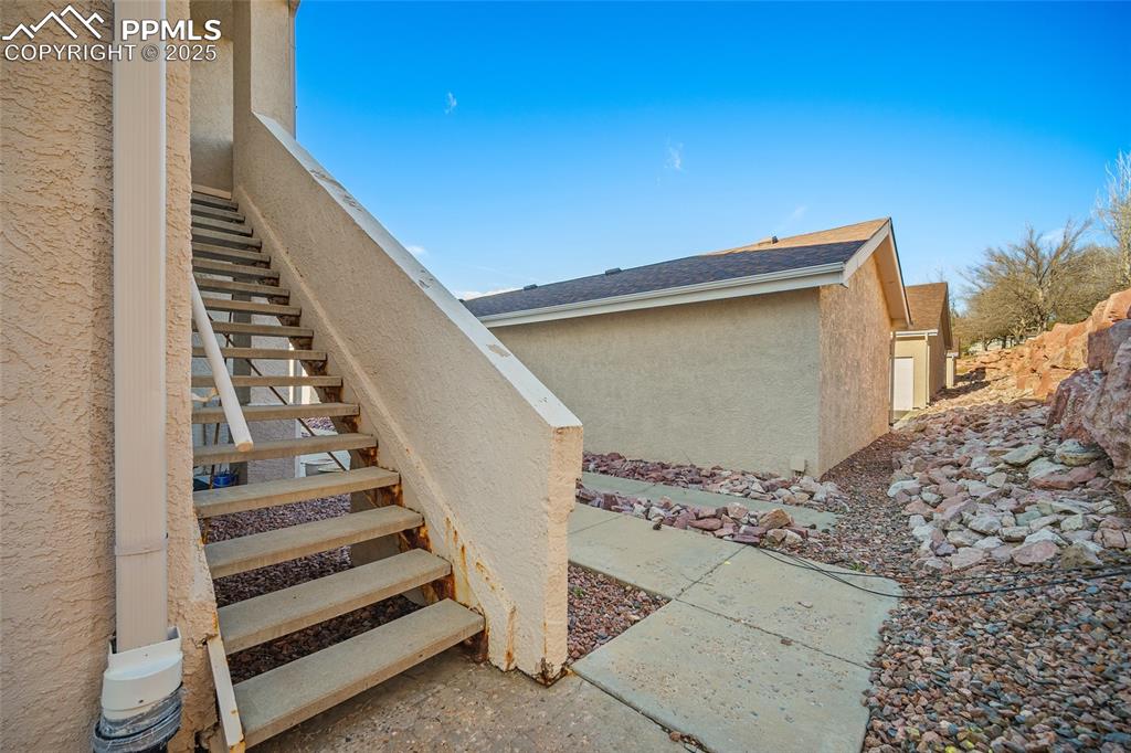 Image 22 of 31: path to garage from bottom of home stairs