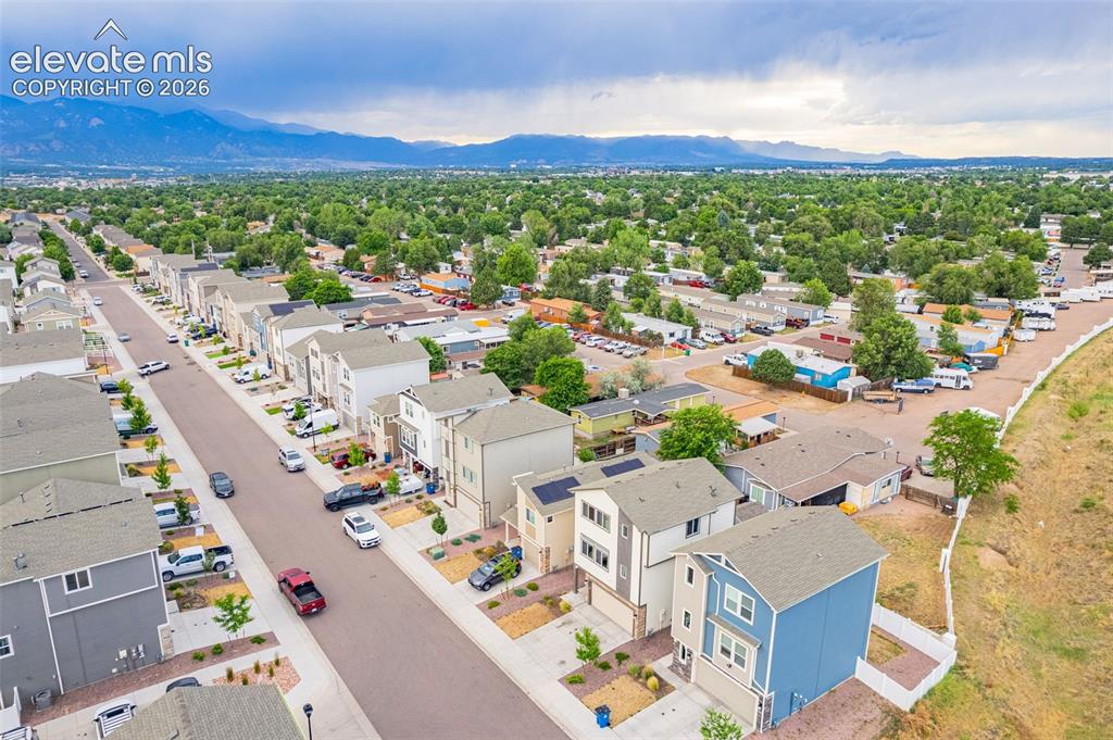 Image 13 of 46: Aerial perspective showcasing a residential area with street parking, estab