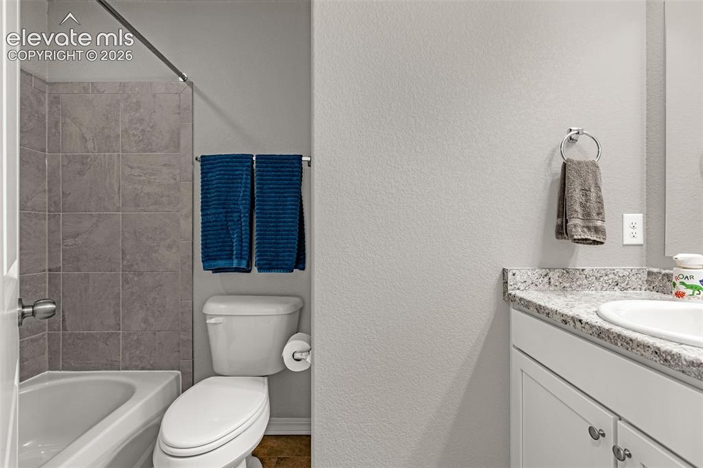 Image 34 of 46: Bathroom featuring a white bathtub with a tiled shower surround, a white to