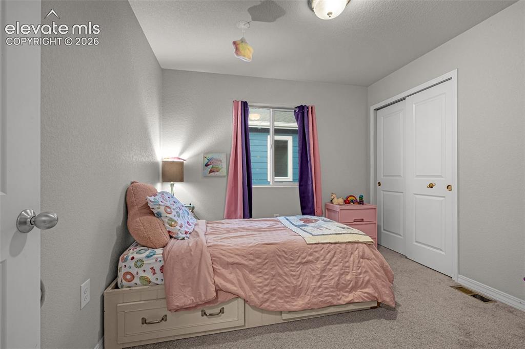Image 37 of 46: Interior room featuring light gray walls and plush carpeting
