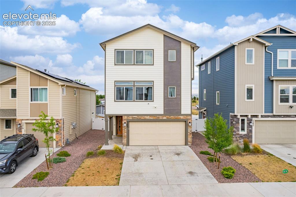 Image 8 of 46: Modern facade featuring a mix of horizontal siding, vertical accents, and s