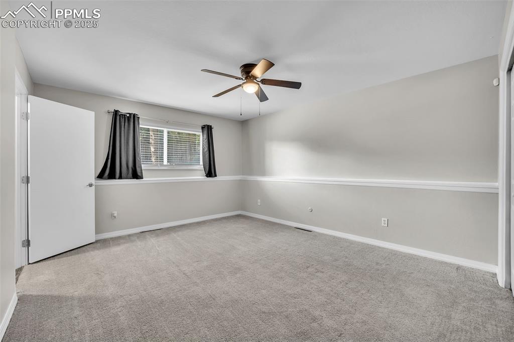 Image 18 of 49: Unfurnished room with light colored carpet and a ceiling fan