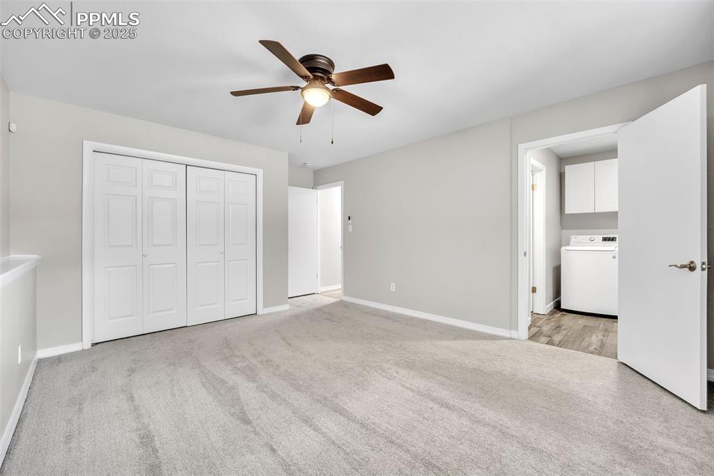 Image 19 of 49: Unfurnished bedroom featuring light colored carpet, washer / clothes dryer,